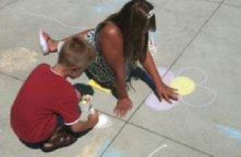 Kristen McEachron and her brother Garrett draw sidewalk pictures at the Thousand Oaks Library. 